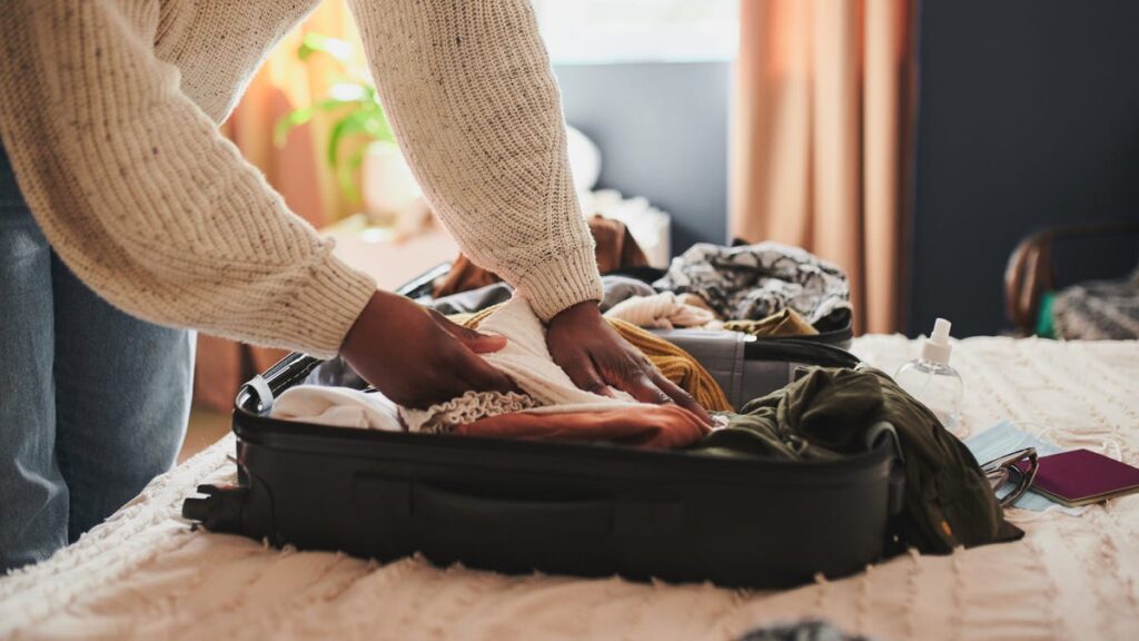 Person packing a suitcase