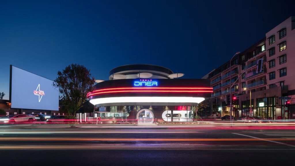 A red and white Tesla Supercharger for charging electric vehicles