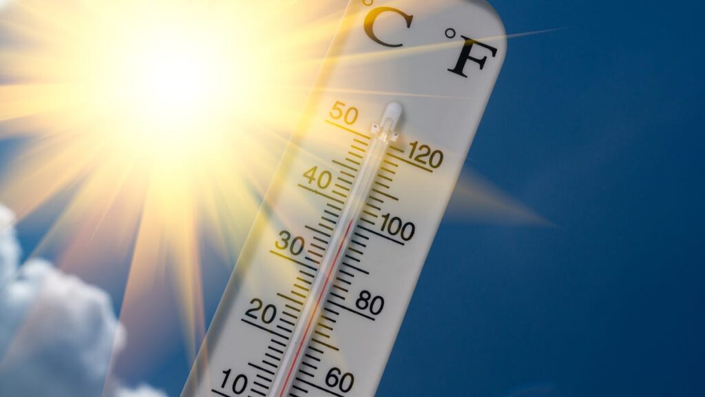 A thermostat against the sun and sky.