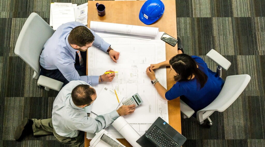 Workers in an office gathered around a table.
