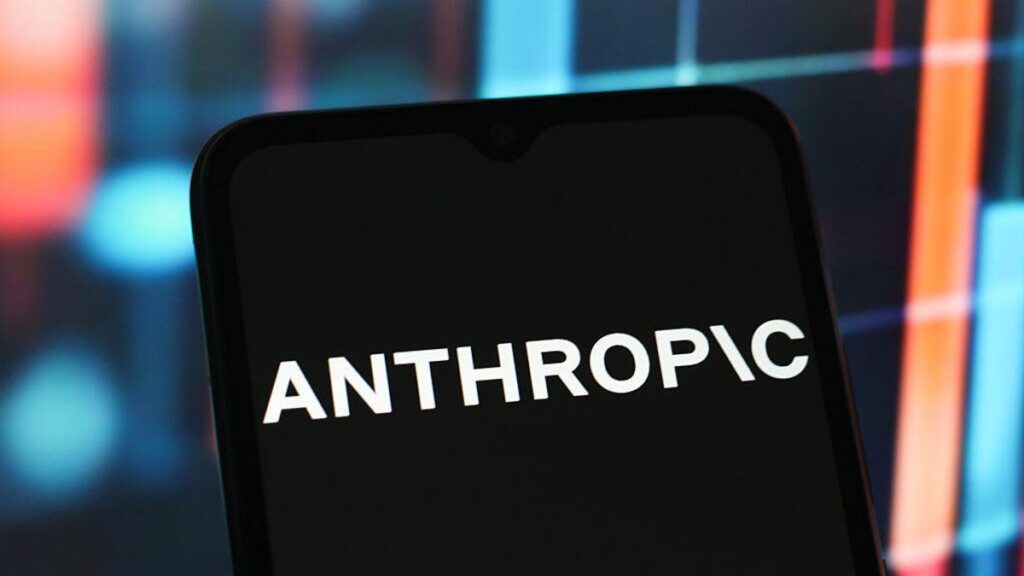 Anthropic logo on a black phone in front of a rainbow background
