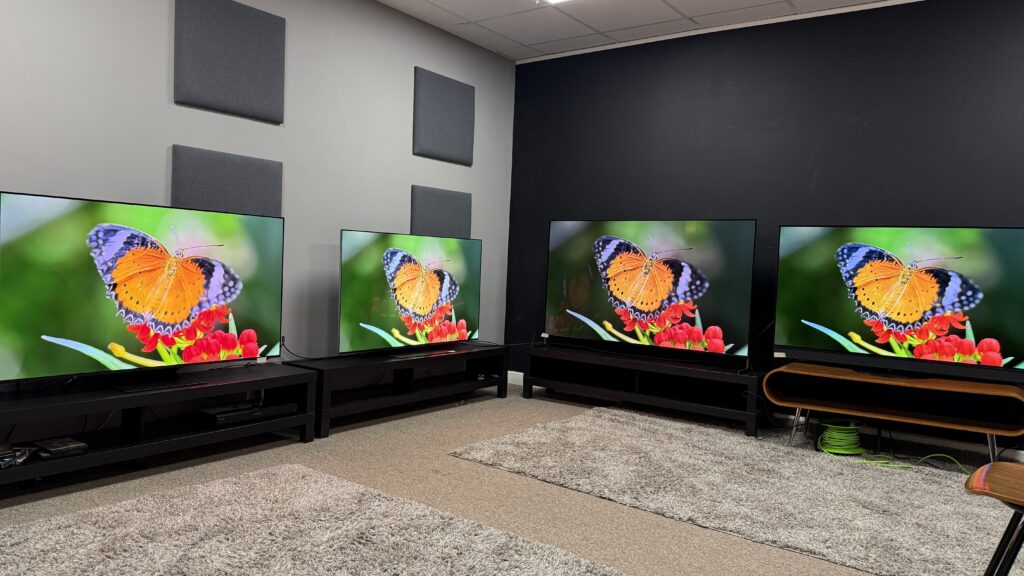 Samsung S95F(far left) LG G5 (middle left) Sony Bravia 8 II (middle right) Panasonic Z95B OLED TV (far right) all showing orange butterfly on screen