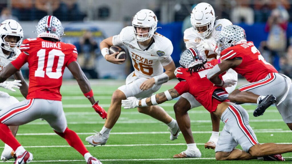 Texas Longhorns quarterback Arch Manning (#16) runs up field for a first down during the CFP Semifinal Cotton Bowl Classic football game between the Ohio State Buckeyes and Texas Longhorns on January 10, 2025 at AT&T Stadium in Arlington, TX