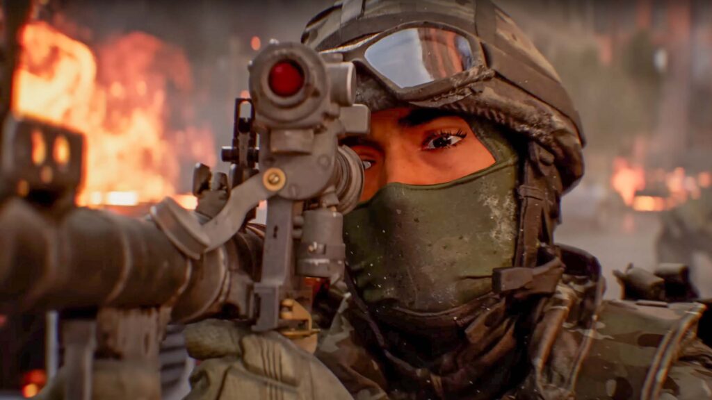 A soldier holding a gun sight up to their eye while there are explosions in the background.