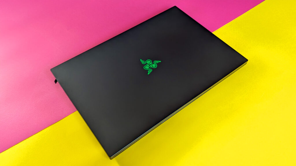 Razer Blade 18 (2025) gaming laptop on a pink and yellow background.