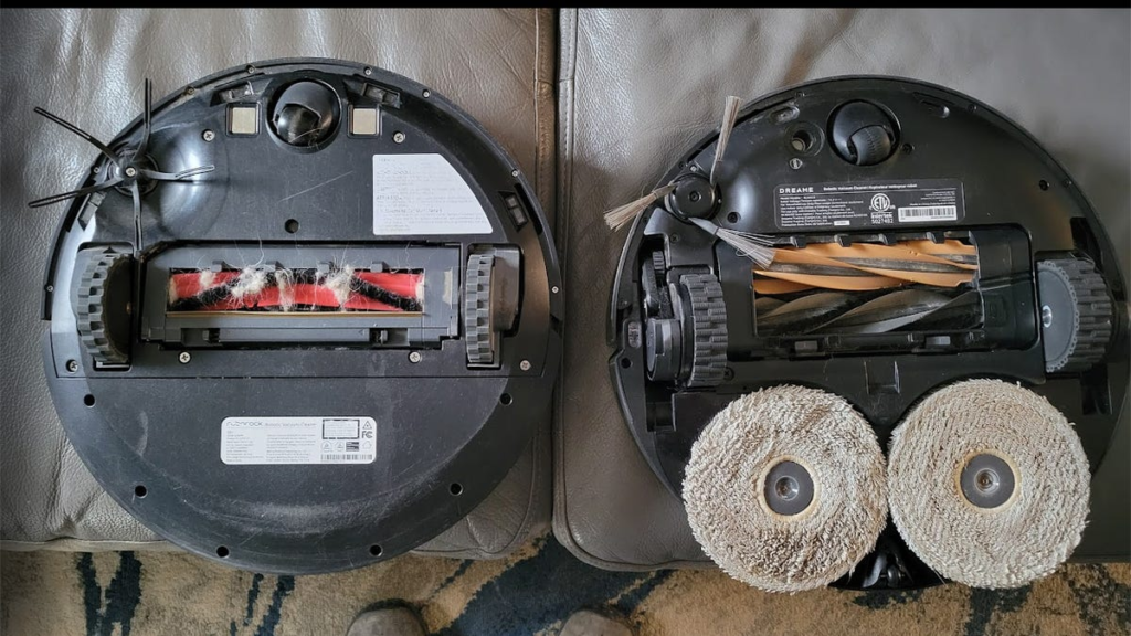 Two robo vacuums side by side with rollers exposed.