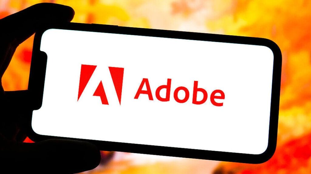 Adobe logo on a smartphone in front of a orange, red and yellow background