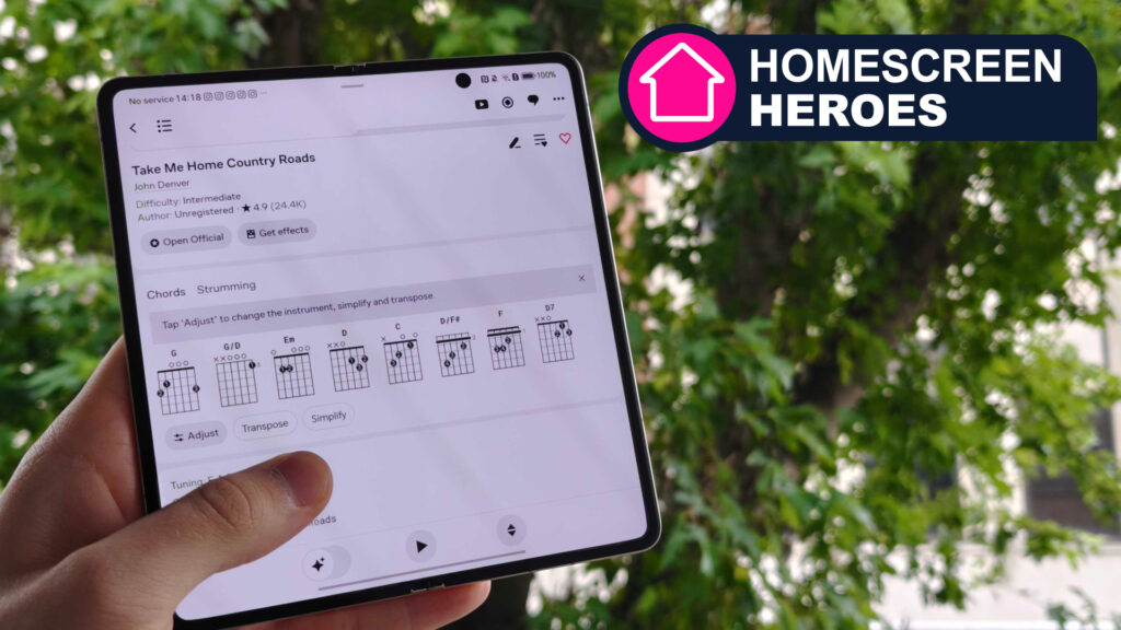 Ultimate Guitar open on a folding phone. Tree in the background