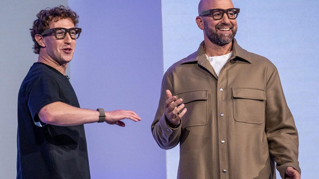 Mark Zuckerberg, chief executive officer of Meta Platforms Inc., left, and Andrew Bosworth, chief technology officer and head of Reality Labs, wear Meta Ray-Ban Display AI glasses during the Meta Connect event