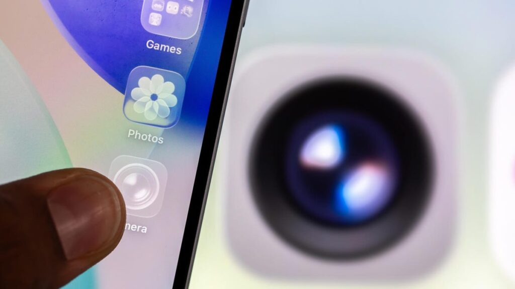 An iPhone with clear app icons. The Camera app icon is behind the iPhone.