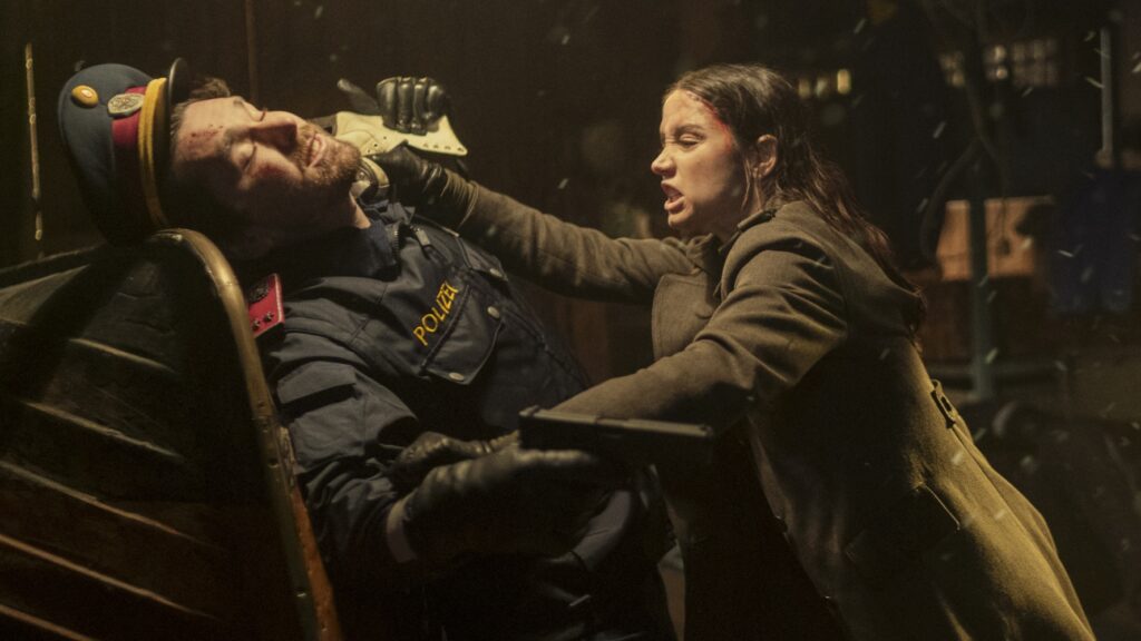 Eve (Ana de Armas) fighting an armed police officer in Ballerina