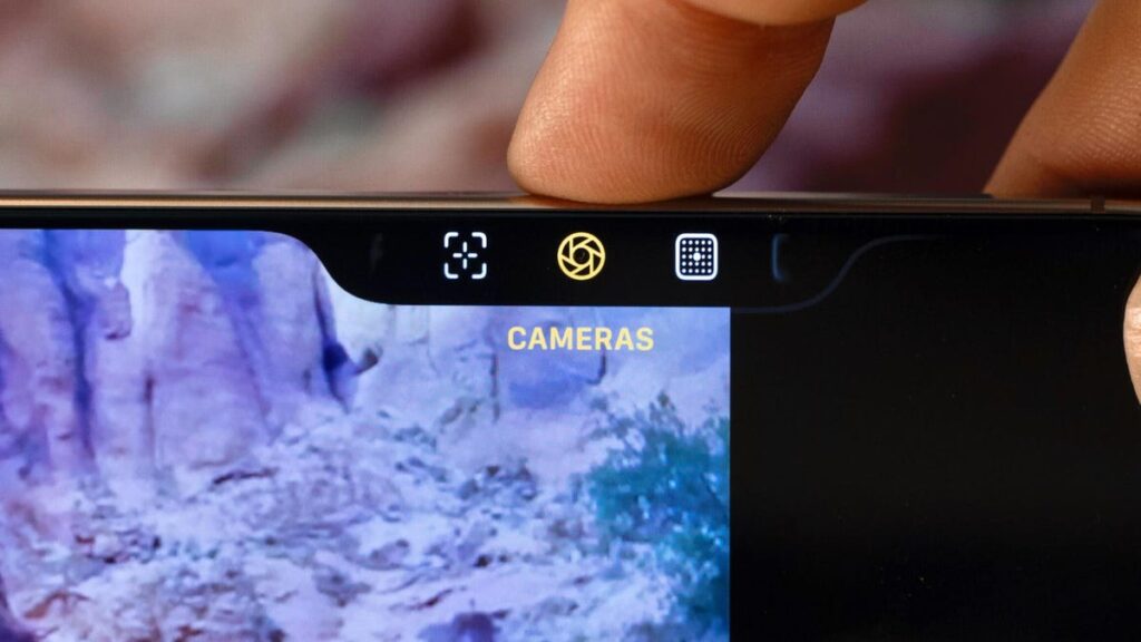 I Made My iPhone a Little Bit Dumber and It’s Made My Life So Much Better A finger pressing the iPhone 16's camera control button