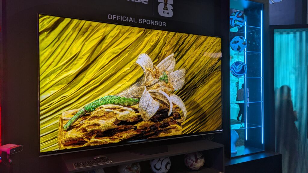 Hisense 85-inch RGB mini-LED TV with flower and yellow background on screen