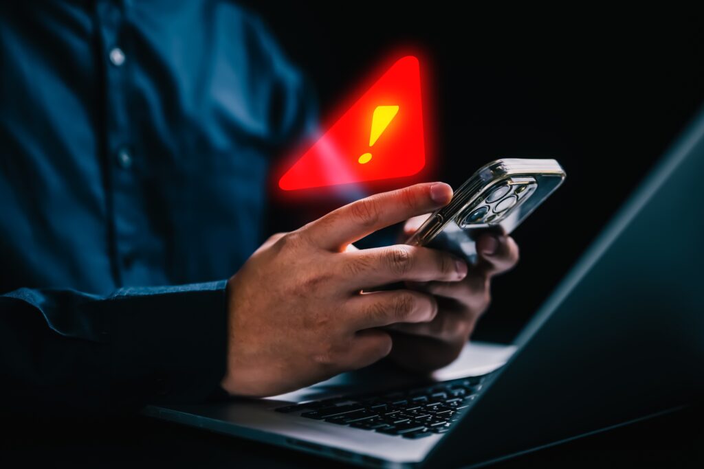 Mobile apps leaking data at alarming rates show iOS and Android users need urgent security measures today Person with warning notification and spam message icon on mobile phone