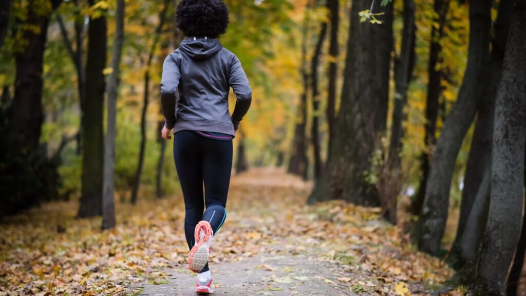 Woman jogging through the woods