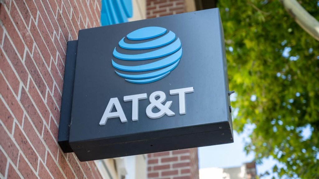 Time Is Running Out to Claim Your Share of AT&T’s Gigantic $177 Million Legal Settlement an AT&T sign with the company's logo -- a striped blue sphere -- extends from a brick building