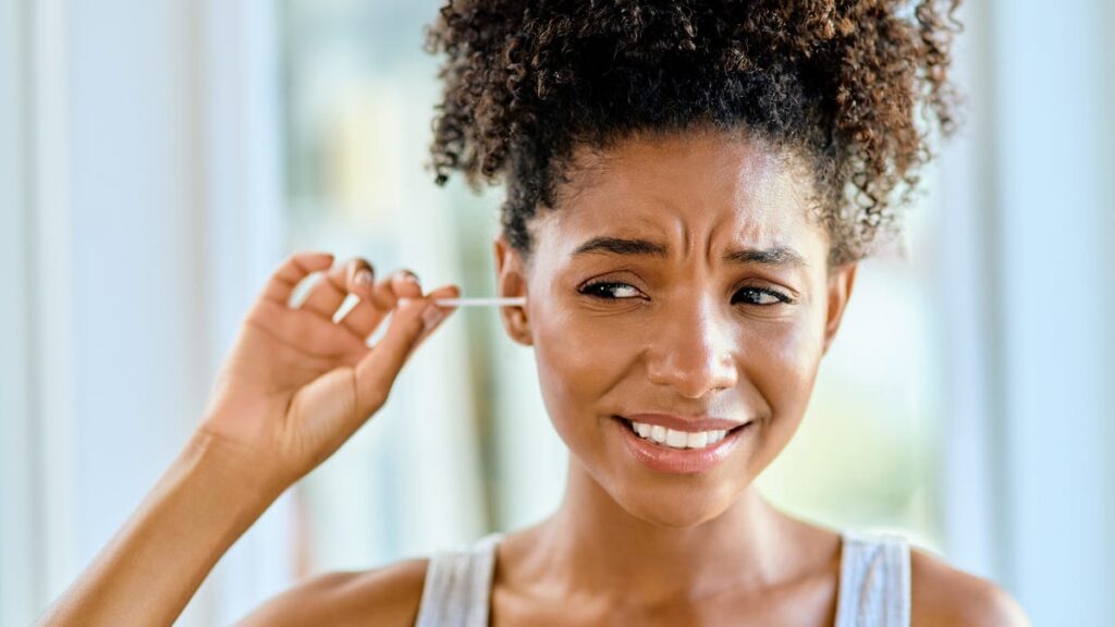 A cotton swab in an ear.