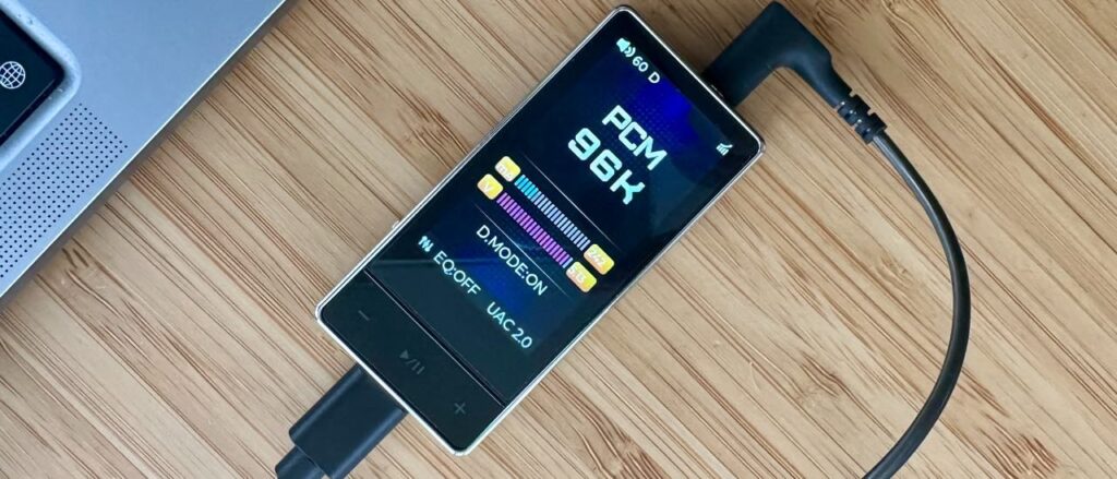 FiiO QX13 headphone amp/DAC on a wooden surface