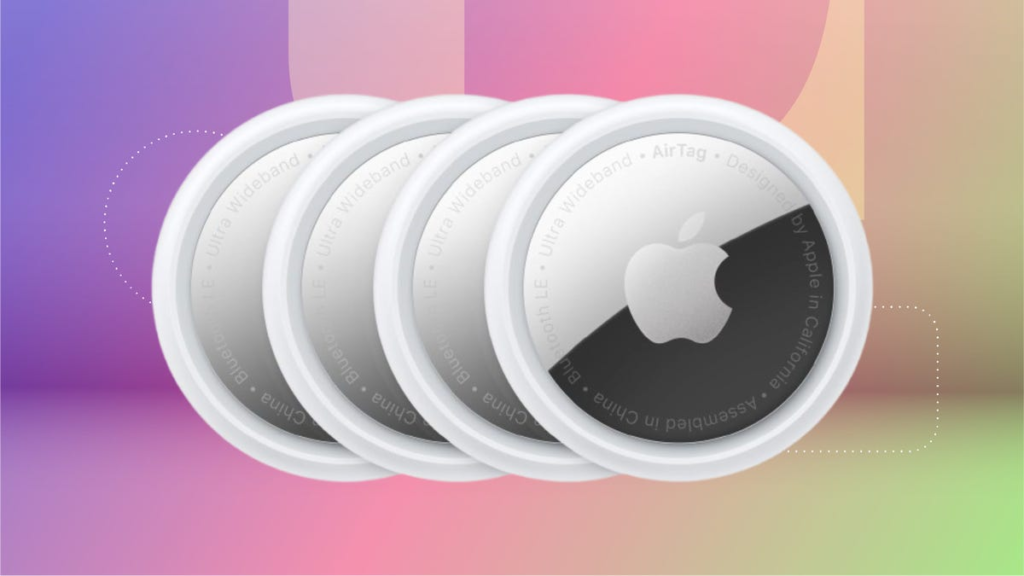 Four white, round Apple AirTags, set against an orange and pink background.
