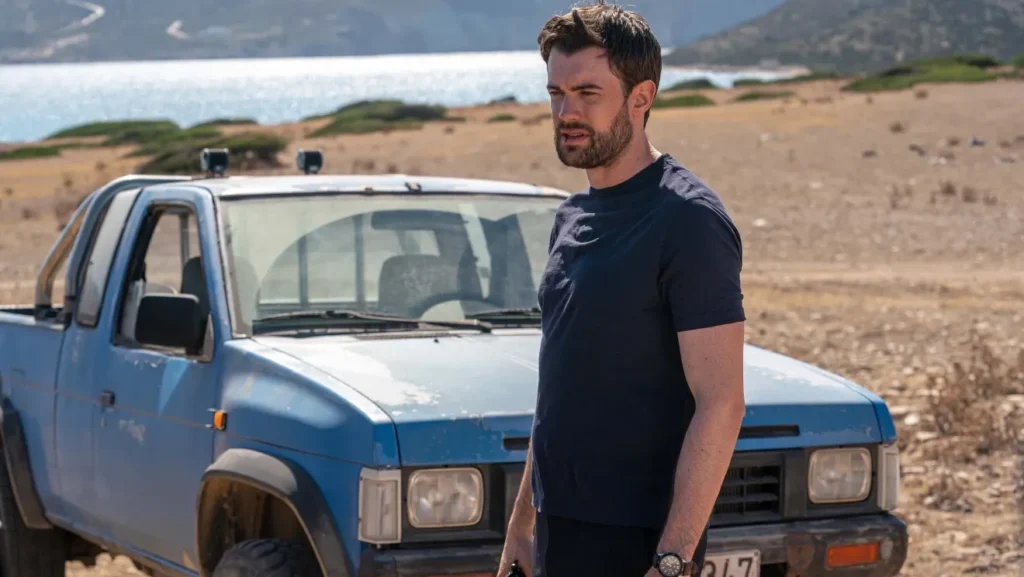 Jack Whitehall ditches British comedy for dark psychological thrills in this new Prime Video show Jack Whitehall in a still from Malice. He's in front of a battered blue pickup near a lake