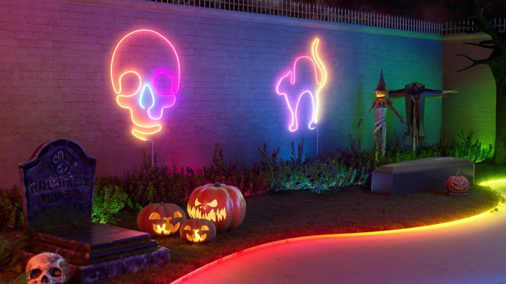 Cync light strips in colorful Halloween shapes on an outdoor wall.