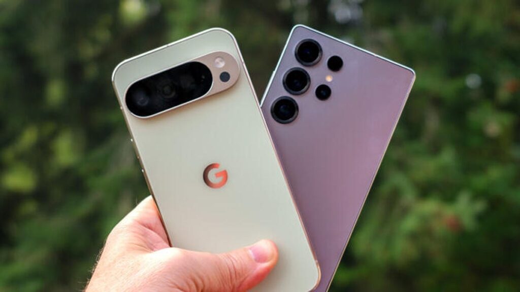A hand holding a light green Pixel 10 Pro XL phone and a silver Galaxy S25 Ultra phones
