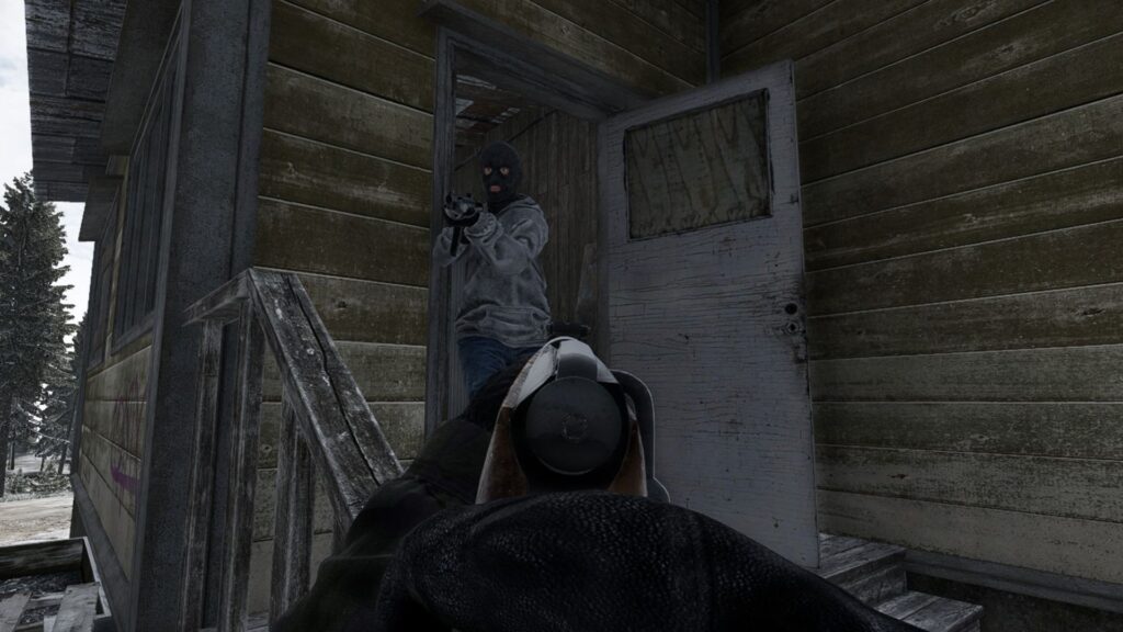 A player points a Mosin rifle at a bandit emerging from a house in Road to Vostok.