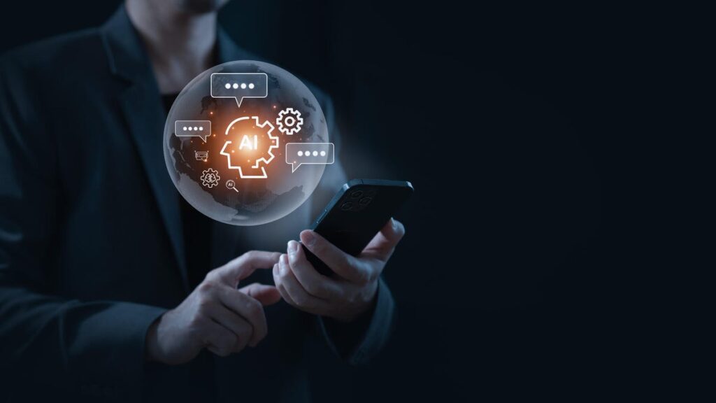 A man in the dark holds a phone with an AI chatbot bubble floating above it.