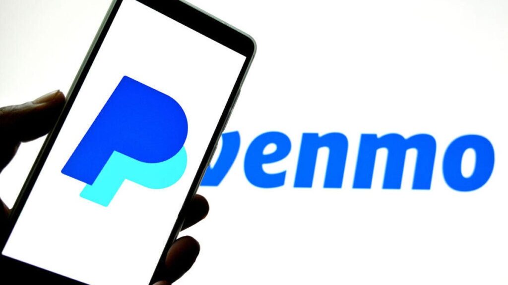 A phone with a PayPal "P" logo held in front of a blue Venmo logo.